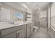 The bathroom features a double sink vanity with a quartz countertop and a glass shower at 2966 Aqua Virgo Loop # 16, Orlando, FL 32837