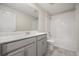 The bathroom features a double sink vanity with a quartz countertop and a shower over tub at 2966 Aqua Virgo Loop # 16, Orlando, FL 32837