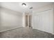 Neutral bedroom showcasing a closet, gray carpet and doorway to another room at 2966 Aqua Virgo Loop # 16, Orlando, FL 32837