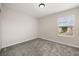 This bedroom features neutral walls, a window with blinds, and plush gray carpeting at 2966 Aqua Virgo Loop # 16, Orlando, FL 32837