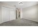 Neutral bedroom showcasing a closet, gray carpet and doorway to another room at 2966 Aqua Virgo Loop # 16, Orlando, FL 32837