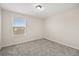 This bedroom features neutral walls, a window with blinds, and plush gray carpeting at 2966 Aqua Virgo Loop # 16, Orlando, FL 32837