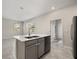 Kitchen island with stainless steel dishwasher and sink, offering a modern convenience in the kitchen area at 2966 Aqua Virgo Loop # 16, Orlando, FL 32837