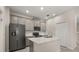 Modern kitchen with stainless steel appliances, a center island, and ample cabinet space for storage at 2966 Aqua Virgo Loop # 16, Orlando, FL 32837