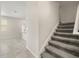 An interior view of a carpeted staircase, seamlessly connecting the different levels of the home at 2966 Aqua Virgo Loop # 16, Orlando, FL 32837