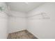 A simple walk-in closet with white walls and metal shelving on the sides and back at 2966 Aqua Virgo Loop # 16, Orlando, FL 32837