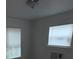 Modest bedroom featuring bright windows with blinds and overhead lighting at 3029 Azalea Ave, Lake Wales, FL 33898