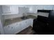 Functional kitchen featuring white cabinets, modern countertops, and black appliances at 3029 Azalea Ave, Lake Wales, FL 33898
