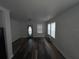 Bright living room with wood-look floors, multiple windows, and an inviting front door at 3029 Azalea Ave, Lake Wales, FL 33898