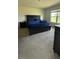 Bright bedroom features a large bed and carpet flooring, complemented by natural light from a window at 30346 Armenia Rd, Leesburg, FL 34748