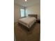 A cozy bedroom with neutral tones and a comfortable bed perfect for rest and relaxation at 30346 Armenia Rd, Leesburg, FL 34748