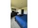 Well-lit bedroom with a dark wood dresser and a comfortable bed, creating a cozy and inviting space at 30346 Armenia Rd, Leesburg, FL 34748