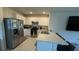 Bright kitchen featuring stainless steel appliances, tiled floors, and a breakfast bar at 30346 Armenia Rd, Leesburg, FL 34748