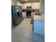 Well-equipped kitchen with stainless steel appliances, white cabinets, and tiled flooring at 30346 Armenia Rd, Leesburg, FL 34748