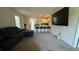 Open-concept living room with carpet flooring, modern furnishings, and a breakfast bar at 30346 Armenia Rd, Leesburg, FL 34748