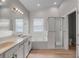 Bright bathroom with dual sinks, soaking tub, and a glass-enclosed shower at 3310 Cat Brier Trl, Harmony, FL 34773