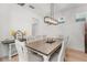Elegant dining room with a stylish chandelier, wood table, and comfortable seating at 3310 Cat Brier Trl, Harmony, FL 34773