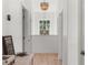 Bright hallway with hardwood floors, chandelier and a window that lets in natural light at 3310 Cat Brier Trl, Harmony, FL 34773