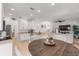 Eat-in kitchen view to living room with stainless steel appliances, neutral walls, and wood-look flooring at 3310 Cat Brier Trl, Harmony, FL 34773