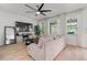 Bright living room features neutral walls, wood flooring, and large windows providing plenty of natural light at 3310 Cat Brier Trl, Harmony, FL 34773