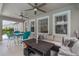 Covered patio with plenty of seating, including a couch, table and chairs at 3310 Cat Brier Trl, Harmony, FL 34773
