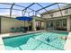 Sparkling pool featuring a screened enclosure, outdoor seating area, and clear water perfect for recreation at 3310 Cat Brier Trl, Harmony, FL 34773