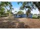 Back of the home and backyard behind the property on a sunny day at 410 Kentia Rd, Casselberry, FL 32707