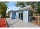 Back of blue home with sliding glass door to the back patio and yard at 410 Kentia Rd, Casselberry, FL 32707