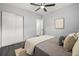 Bedroom featuring hardwood floors, sliding door closet, and ample lighting at 410 Kentia Rd, Casselberry, FL 32707