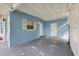 Spacious carport featuring painted concrete block walls and a durable gray painted concrete floor providing ample covered parking at 410 Kentia Rd, Casselberry, FL 32707