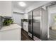 Bright kitchen with stainless steel refrigerator, white cabinets, and modern appliances at 410 Kentia Rd, Casselberry, FL 32707