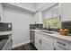 Bright kitchen with modern white cabinets, sleek appliances, and stylish backsplash at 410 Kentia Rd, Casselberry, FL 32707