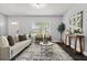Inviting living room with a neutral palette, large window, and comfortable seating arrangement at 410 Kentia Rd, Casselberry, FL 32707