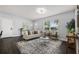 Bright living room with natural light, modern furnishings, and stylish rug create a welcoming space at 410 Kentia Rd, Casselberry, FL 32707