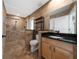 Beautiful bathroom with granite countertop, tiled walls, and glass-enclosed shower at 415 Smiley Ct, Winter Haven, FL 33884