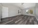 Spacious bedroom with wood floors, ceiling fan, and access to the screened-in porch at 415 Smiley Ct, Winter Haven, FL 33884