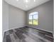 Bedroom featuring wood flooring and a large window at 415 Smiley Ct, Winter Haven, FL 33884