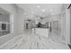Open concept kitchen area featuring white cabinets and marble floors at 415 Smiley Ct, Winter Haven, FL 33884