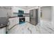 Kitchen featuring white cabinets, stainless steel appliances and blue accents at 415 Smiley Ct, Winter Haven, FL 33884