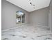 Bright, airy room with marble floors, featuring a large window offering a neighborhood view at 415 Smiley Ct, Winter Haven, FL 33884
