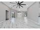 Spacious living room featuring elegant marble floors, a modern ceiling fan, and arched doorways at 415 Smiley Ct, Winter Haven, FL 33884