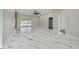 Open-concept living area featuring marble floors, sliding glass doors to the patio, and neutral walls at 415 Smiley Ct, Winter Haven, FL 33884