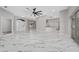 Expansive living area with marble floors, a modern ceiling fan, and an open layout perfect for entertaining at 415 Smiley Ct, Winter Haven, FL 33884