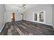 Bright main bedroom featuring wood floors, ceiling fan, and ensuite bathroom at 415 Smiley Ct, Winter Haven, FL 33884