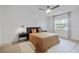 Calm bedroom featuring a queen bed, neutral color scheme, and a well-lit window at 4768 Tangerine Ave # 4768, Winter Park, FL 32792