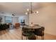 Bright dining area with modern light fixture and open access to the living room and kitchen at 4768 Tangerine Ave # 4768, Winter Park, FL 32792