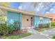 Inviting single-story villa featuring a covered entryway with landscaping and a well-maintained lawn at 4768 Tangerine Ave # 4768, Winter Park, FL 32792
