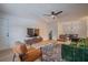 Inviting living room with stylish furniture, wood flooring, ceiling fan, and a view into the dining area at 4768 Tangerine Ave # 4768, Winter Park, FL 32792