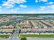 Beautiful aerial view of a condo community, featuring a large number of homes, lush landscaping, and a serene lake at 4981 Windermere Ave, Kissimmee, FL 34746