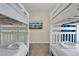 Cozy bedroom between two white bunk beds, with a television and comfortable bedding at 4981 Windermere Ave, Kissimmee, FL 34746